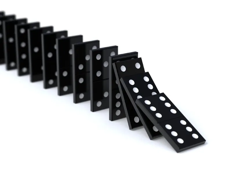 A row of black dominoes toppling over